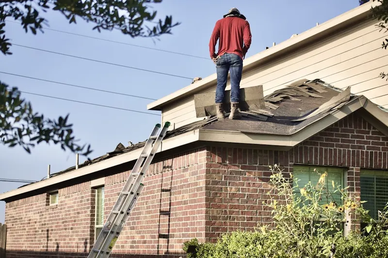 Professional roofer working on a residential roof in Shoalsview